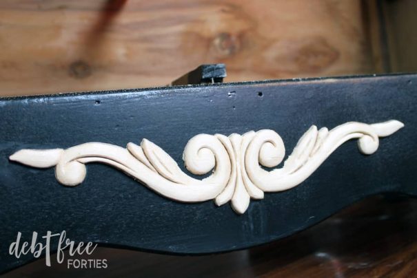Wood applique glued to front of the dresser