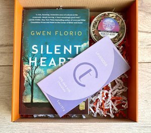 subscription box with book, chocolate and tea
